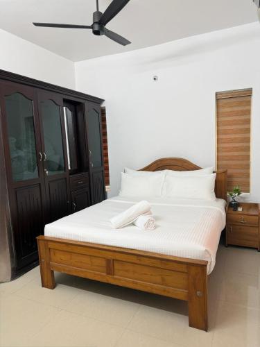 a bedroom with a bed with a towel on it at Zenaura Casa Villa 2 in Cochin