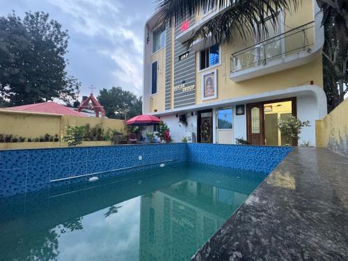 a swimming pool in front of a building at JSP VILLA in Yelagiri