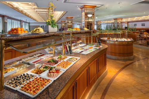 a buffet line with many different types of food at Park Inn by Radisson Berlin Alexanderplatz in Berlin