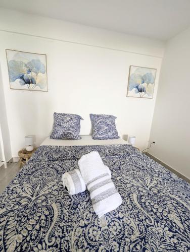 a bedroom with a bed with towels on it at Les locations de Miche in Le Vauclin