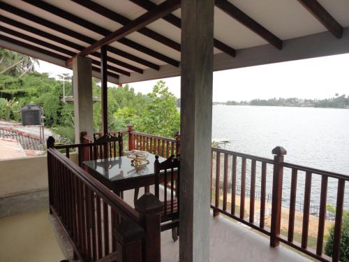 a porch with a view of the water at Sapara River Guest in Bentota