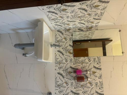 a bathroom with a mirror and a sink at Inn34 By Blessings Hospitality - Porur Near DLF in Chennai