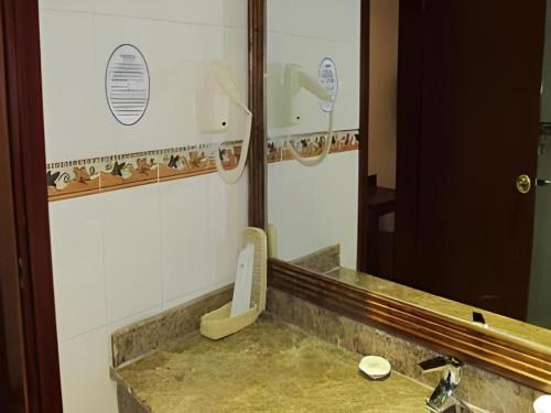 a bathroom with a sink and a mirror at GreenTree Inn Rizhao Yantai Road in Rizhao