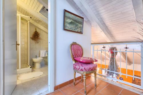 a bathroom with a chair and a toilet at Rivabella Apartment in Poreč
