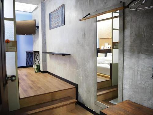 a room with a door leading to a bedroom at Day Hotel Khon Kaen in Khon Kaen