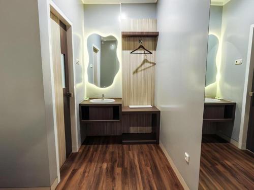 a bathroom with a sink and a mirror at Sunrise Hotel in Malang
