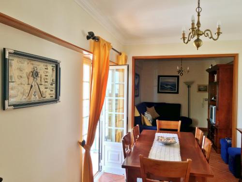 a dining room with a table and a couch at Ericeira Lovers Apartment Center in Ericeira
