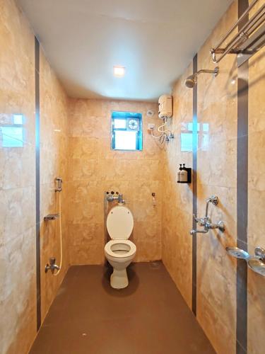 a bathroom with a toilet and a shower at Great Samrat Residency in Khopoli