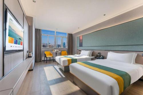 Postel nebo postele na pokoji v ubytování City Comfort Inn Shantou Jinhu Road Branch