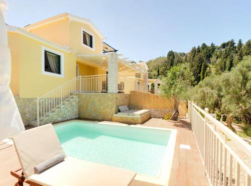 a villa with a swimming pool and a house at Villas Muscalas by Konnect, 200m from the Beach in Lákka