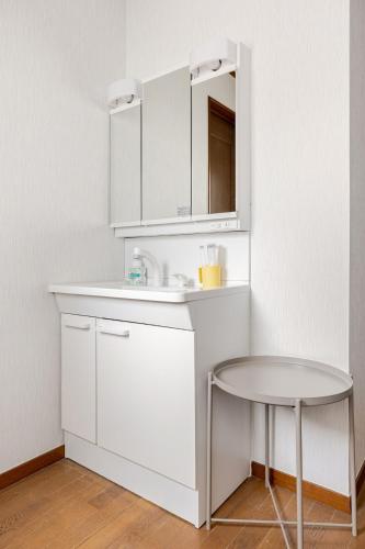 a white kitchen with a sink and a table at New Sale! Tokyo Asakusa Area Emi House in Tokyo