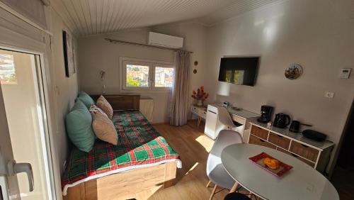 a small bedroom with a bed and a table at Agapi apartment in Florina