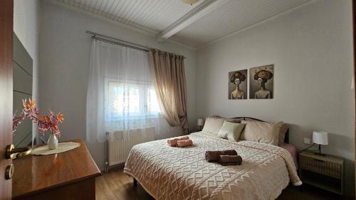 a bedroom with a bed with two towels on it at Agapi apartment in Florina