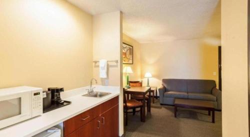 a hotel room with a kitchen and a living room at Quality Inn & Suites Lincoln North in Arbor