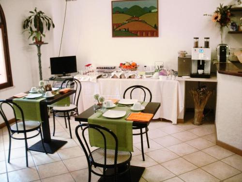 a dining room with tables and chairs and a kitchen at Residence Bizzoni in Terni
