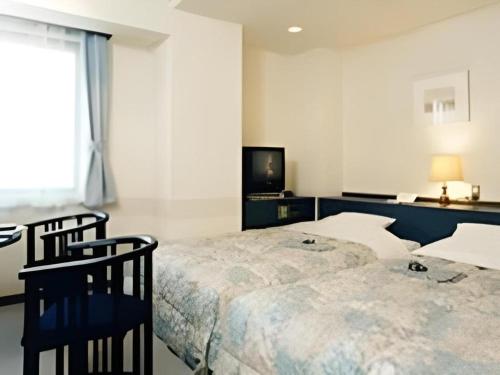 Postel nebo postele na pokoji v ubytování Hirosaki Ekimae Hotel