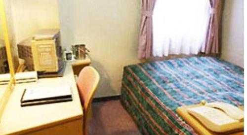 Ένα ή περισσότερα κρεβάτια σε δωμάτιο στο Hotel Half Time