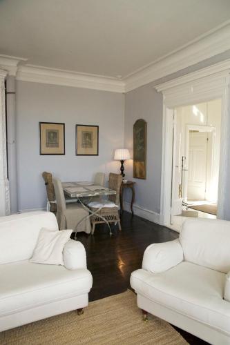 a living room with two white couches and a table at Von Otterska Villan i Gränna in Gränna