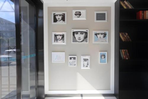 a wall with pictures of people on it at Xana Lite·Nanchang Changbei Jiangxi University of Finance and Economics in Nanchang