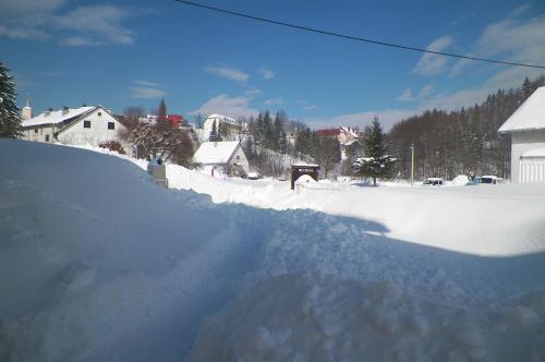 a pile of snow on the side of a house at Apartmani Sabina in Fužine