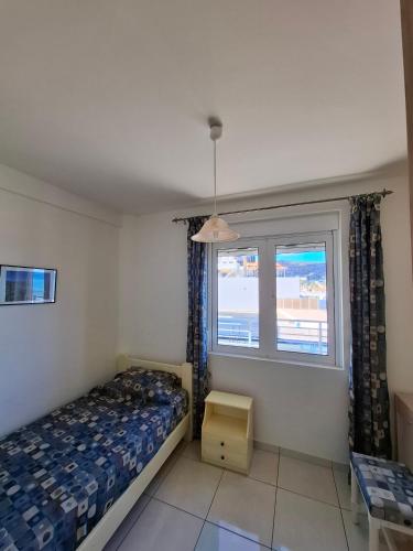 a bedroom with a bed and a window at 4S Beach Superior Apartments in Stalís
