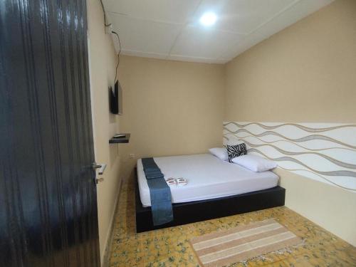 Postel nebo postele na pokoji v ubytování Arwana Inn