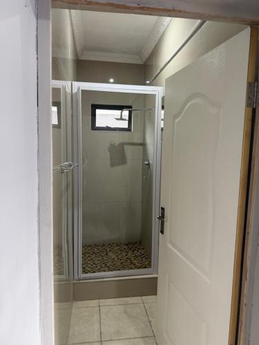 a shower with a glass door in a bathroom at Le Caille, St Lucia Two bedroom unit in St Lucia