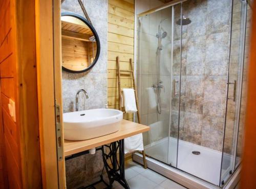 a bathroom with a sink and a shower at Wooden House Vučedol in Vukovar
