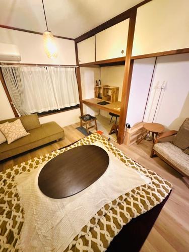 a living room with a large rug on the floor at Minato House 101 in Fukuoka
