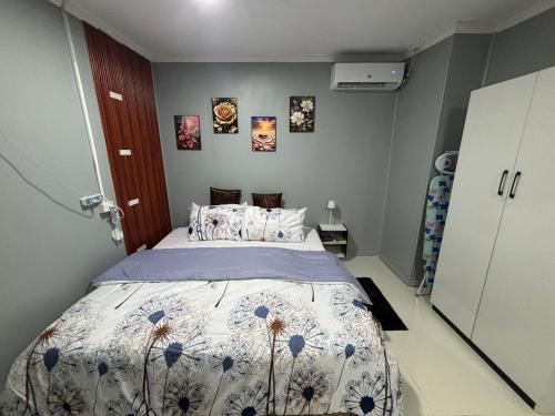 a bedroom with a bed with a floral bedspread at Cocos Stay Executive Studio Flat in Labasa