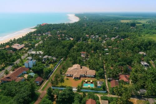 an aerial view of a house next to the beach at Ceylo Villas in Bentota