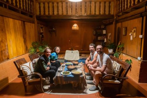 a group of people sitting around a table at Casa De Dobby in Sa Pa