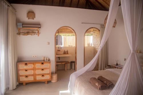 Ein Bett oder Betten in einem Zimmer der Unterkunft Villa Nyantara
