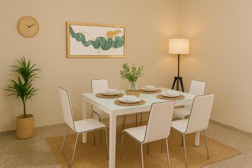 a dining room with a white table and chairs at Bright & Spacious En-suite Room - Santo Domingo Este in Cancino