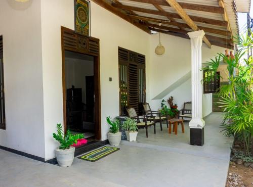 a patio with potted plants in a house at River Island Villa in Ahangama