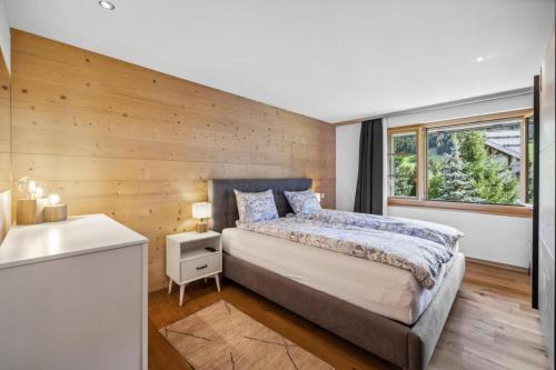 a bedroom with a large bed and a window at Charming Apartment in Gsteig in Gsteig