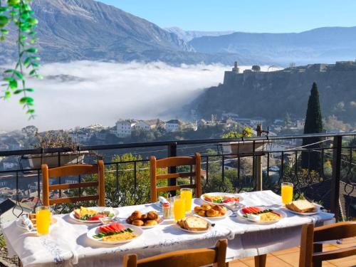 a table with plates of food on top of a mountain at Emblematic House Apartment 4 in Gjirokastër