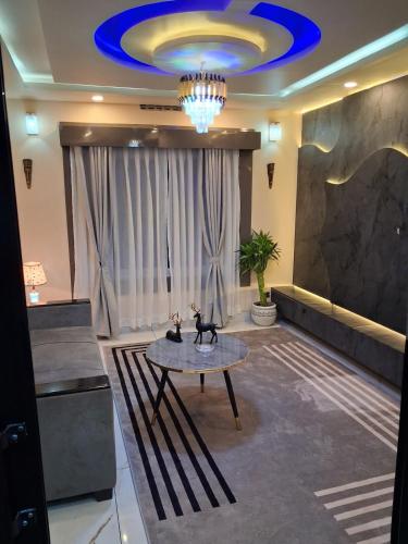 Una habitación con una mesa y un techo azul. en Omnia Luxe Villa, en Pānigata