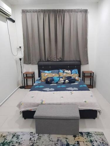 a bedroom with a bed and a window at Alfateh MU5L1M Homestay in Sungai Petani