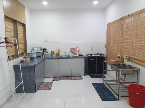 a kitchen with a counter and a sink in it at Alfateh Homestay in Sungai Petani