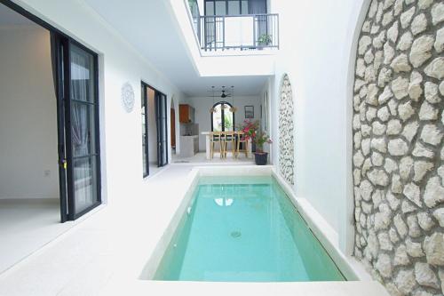 a swimming pool in the middle of a house at Luxury Villa With Private Pool Surrounded by Nature in Mantaak