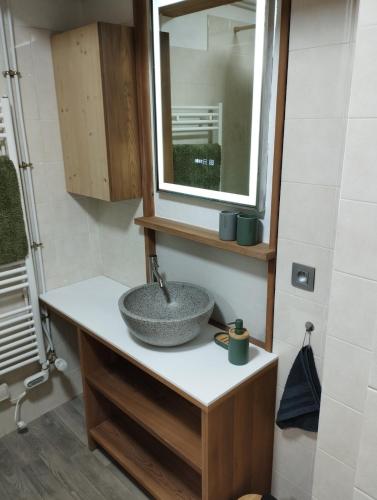 a bathroom with a sink and a mirror at Studio Mont d'Arbois in Megève