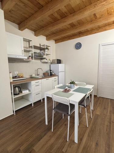 a kitchen with a table and chairs in a room at Sicily Loft Living in Catania