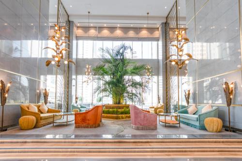 a lobby with colorful furniture and a large window at Thirty Five Westbay Luxury Apartments in Doha