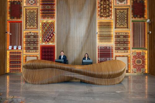 two people sitting in a room with their laptops at Thirty Five Westbay Luxury Apartments in Doha