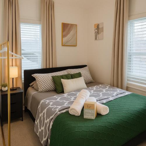 a bedroom with a bed with a green comforter at Modern Room in Shared Apartment Near NYC in Englewood