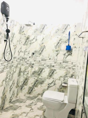 a bathroom with a white toilet and a shower at Azure bay in Matara