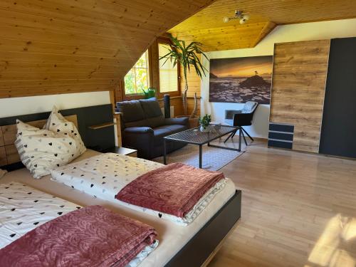 a bedroom with two beds and a living room at Casa Festini in Thomatal