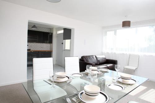a living room with a glass table and a couch at Southside Apartment Glasgow in Glasgow