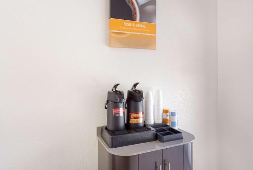 a shelf with two black tools on a wall at Motel 6 Baton Rouge Southeast in Baton Rouge